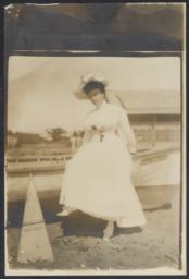 Portrait of unidentified woman in white dress, outdoor, undated : photograph