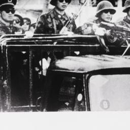 Soldiers on top of truck wi...
