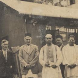 Group of five men standing ...