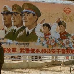 Two Tibetans walking past s...