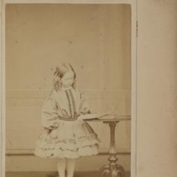 Girl Standing at a Round Table