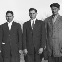 Four Men Standing in a Fiel...