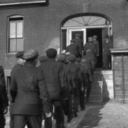 Group of Men Entering a Bui...