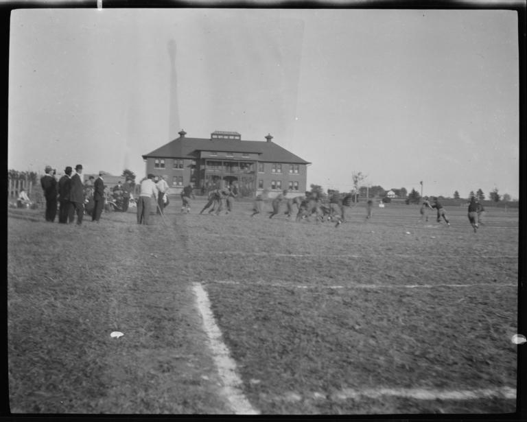 Football Game with Spectators Standing around the Field's Edge, Haskell Institute, Lawrence, Kansas