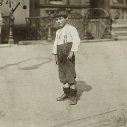 Boy Standing on Sidewalk