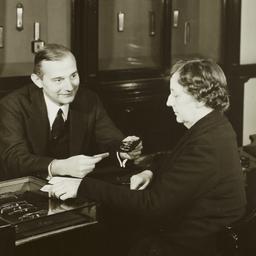 Man Showing Glasses to Woman