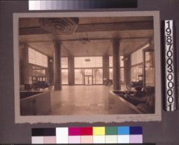 View toward street\, showing built-in furniture\, decorative light fixtures\, and tile-covered columns.