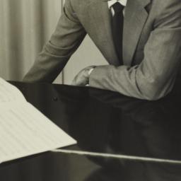 Ulysses Kay leaning on pian...