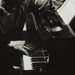 Ulysses Kay playing piano a...